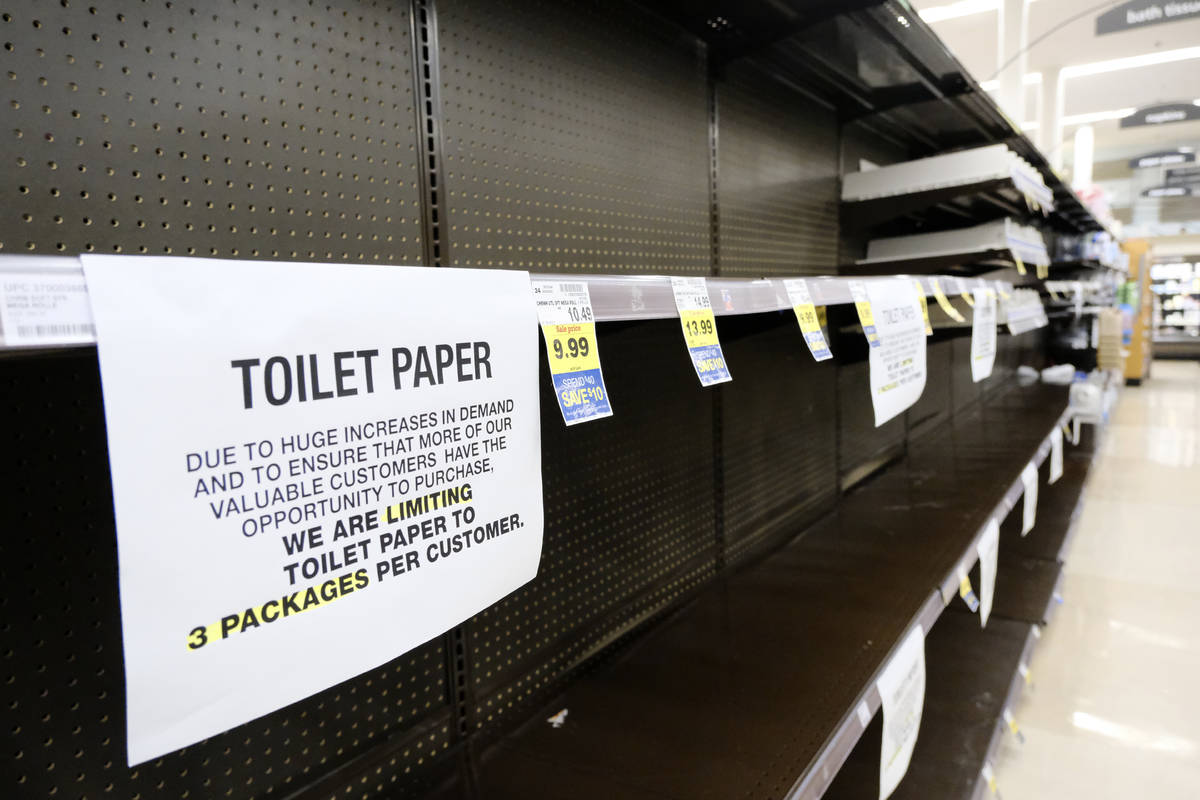 A notice limiting only 3 packages of toilet paper per customer is displayed on picked bare shel ...