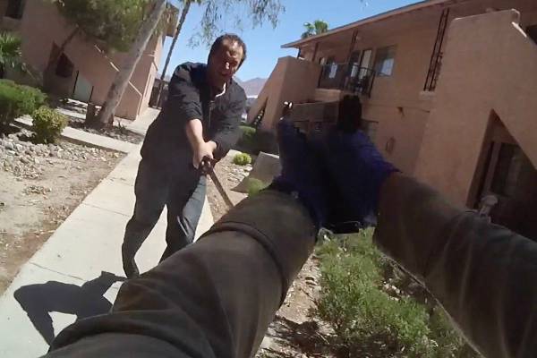 Justin Charland approaches a police officer while wielding a sword shortly before being shot an ...