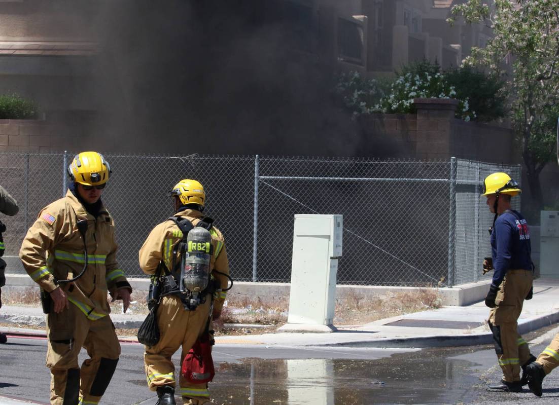 Henderson firefighters battle a fire in a storm drain that generated a large amount of smoke on ...