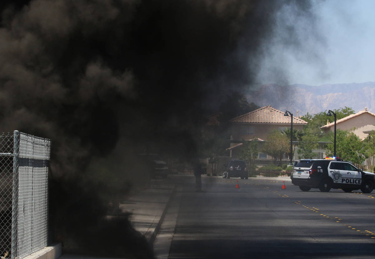 A large amount of smoke was generated as Henderson firefighters battle a fire in a storm drain ...