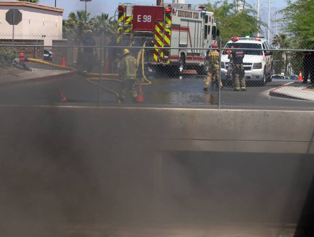 A large amount of smoke was generated as Henderson firefighters battle a fire in a storm drain ...