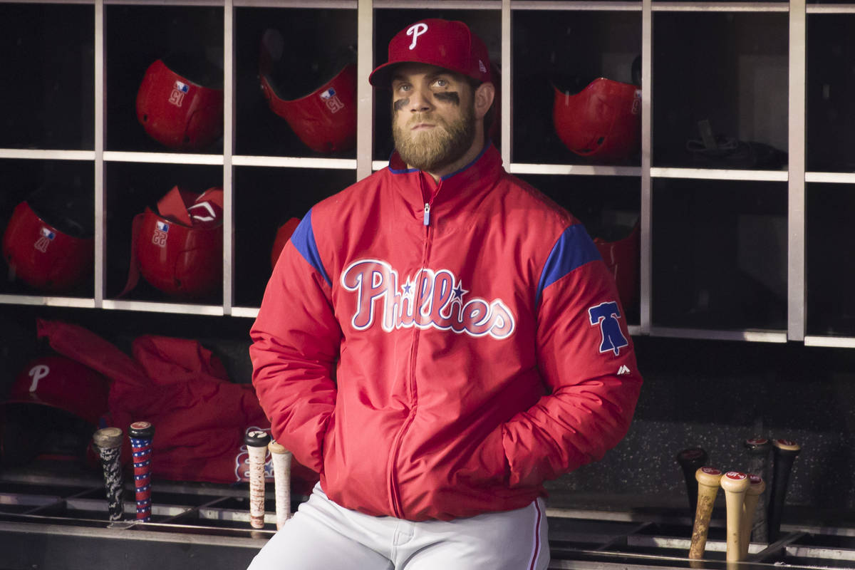 Philadelphia Phillies' Bryce Harper watches a video tribute from the dugout before a baseball g ...