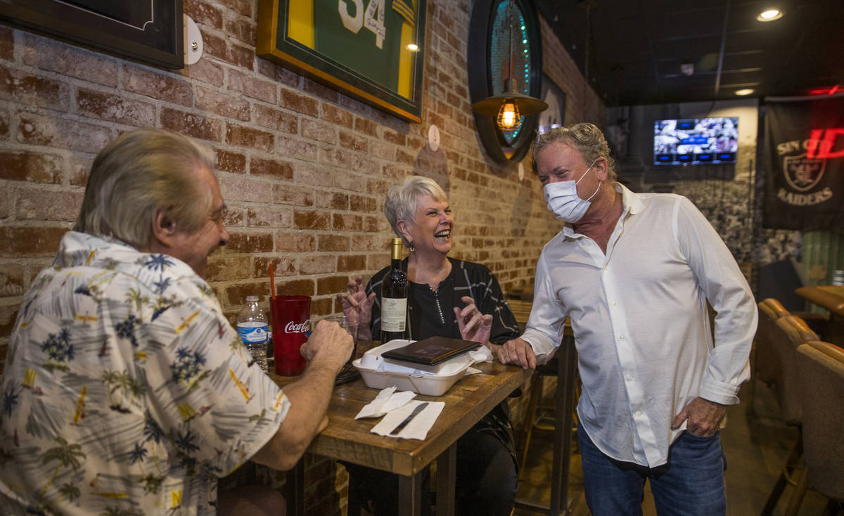 Customers Larry, left, and Lin Meriage share some laughs with Johnny Mac's Sports Bar & Gri ...