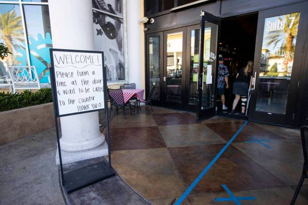 A sign directs customers at Grimaldi's in Boca Park as some restaurants open for table-service ...