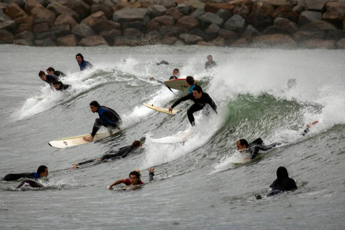 People surf on a beach reopened for sport activities after the lockdown measures imposed by the ...