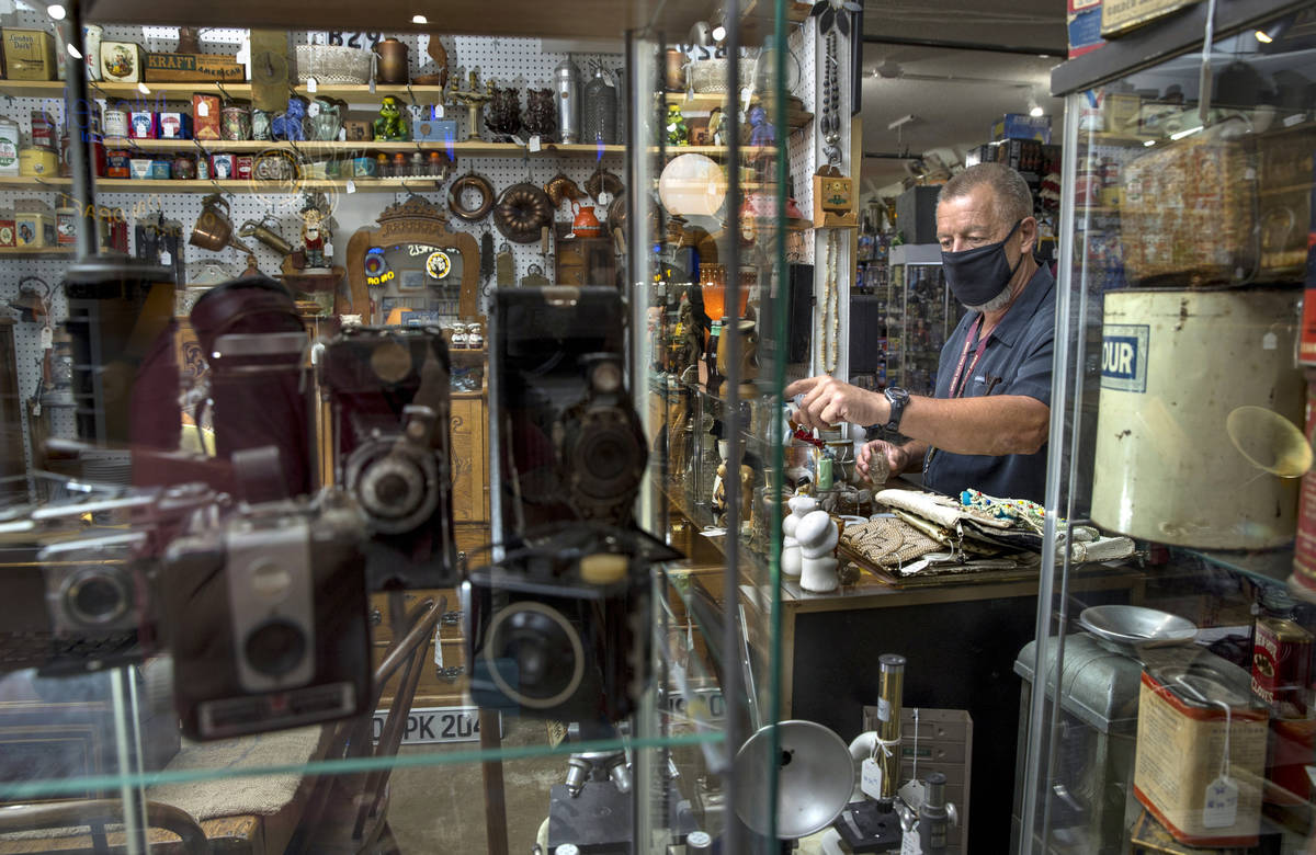 Seller Mark Storm readies the items in one of his stalls for sale within the Antique Alley Mall ...