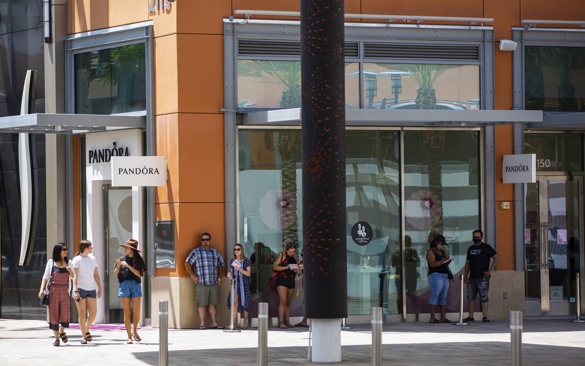 People gather outside of Pandora at Downtown Summerlin as some restaurants and businesses open ...
