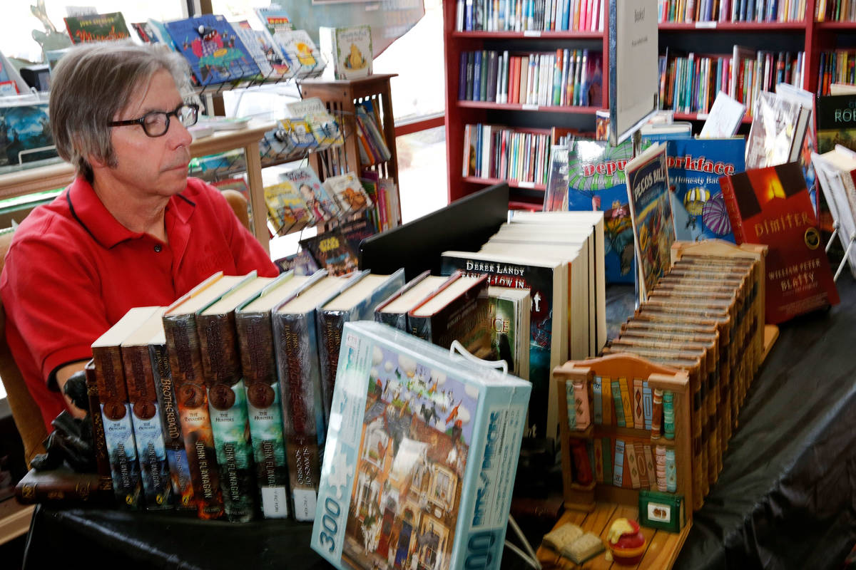 Anthony Marcisofsky, co-owner of Copper Cat Books, works on his laptop in his bookstore in Hend ...