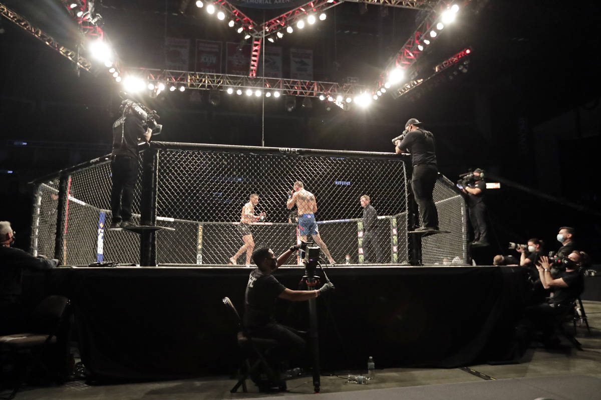 Anthony Pettis, center left, and Donald Cerrone fight during a UFC 249 mixed martial arts bout, ...