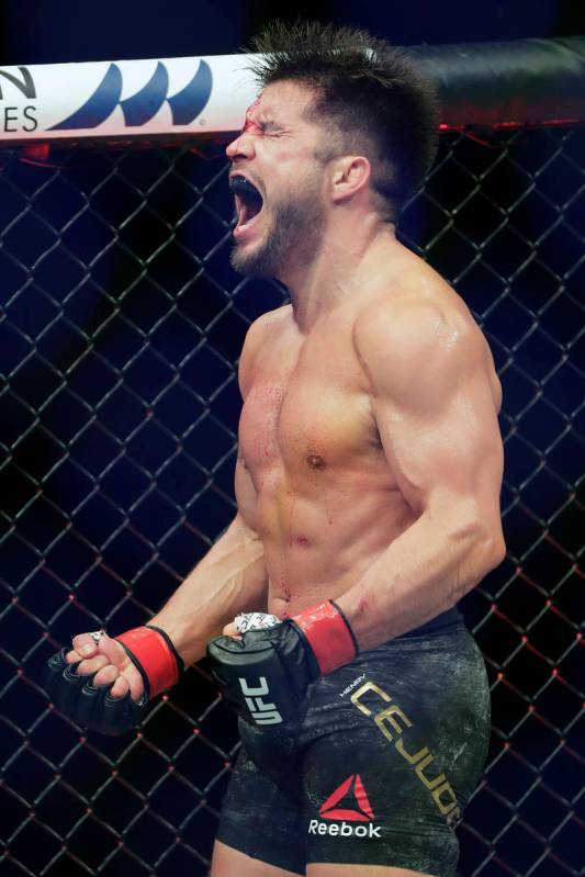 Henry Cejudo celebrates after winning his bout against Dominick Cruz in a UFC 249 mixed martial ...