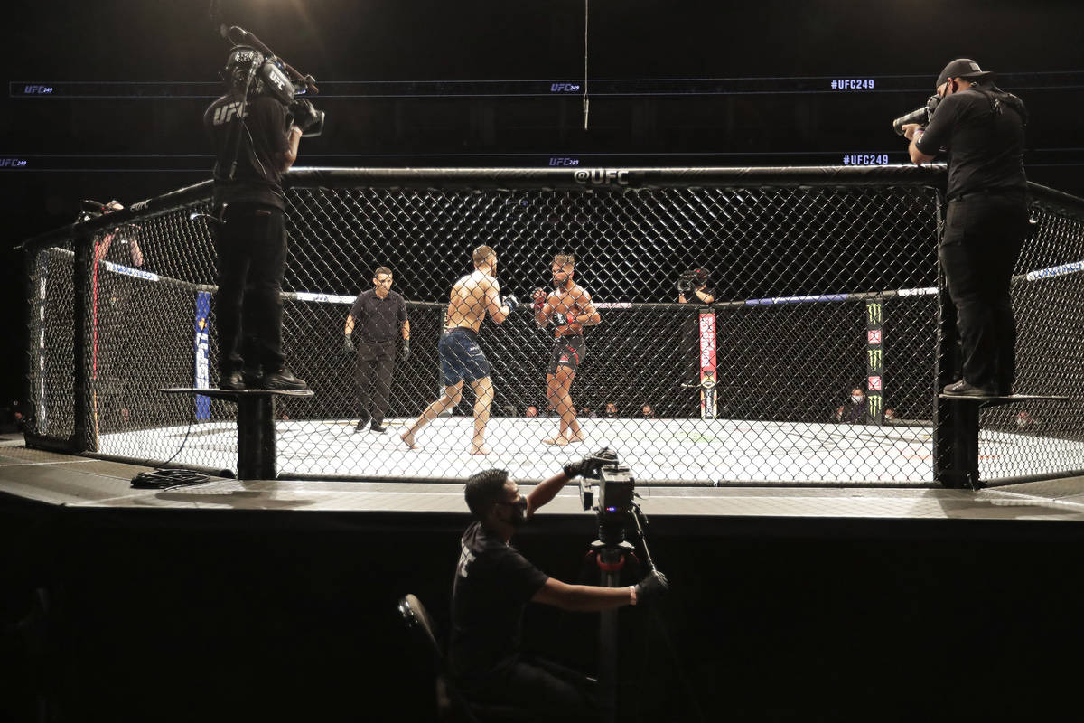 Calvin Kattar, center left, and Jeremy Stephens fight during a UFC 249 mixed martial arts bout, ...