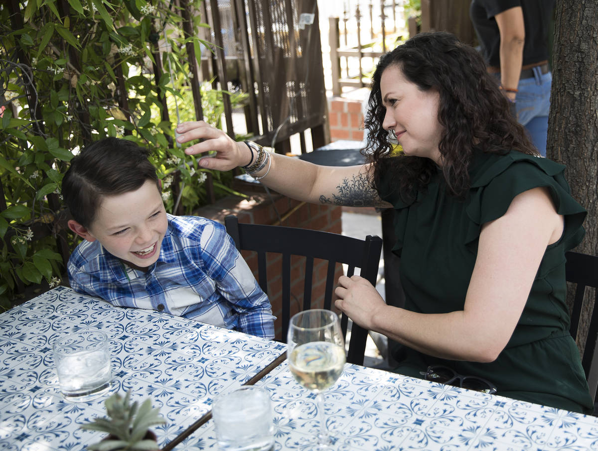 Nicole Silverman fixes the hair of her son Berkeley Brady, 8, while at brunch at 7th & Cars ...