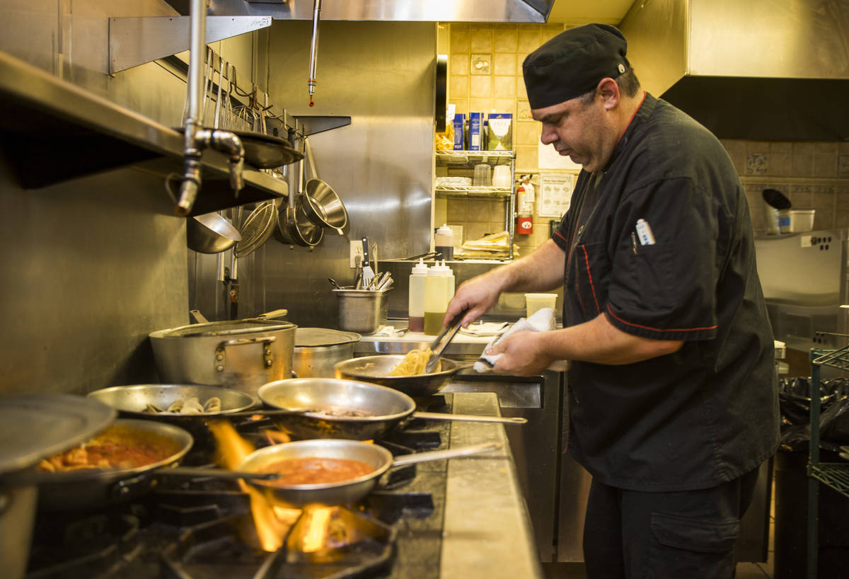 Che and owner Dan Thompson prepares another dish in the kitchen at D'Agostino's Trattoria on Mo ...