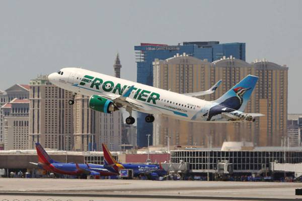 A Frontier Airlines flight departs McCarran International Airport in Las Vegas. (Review-Journal ...