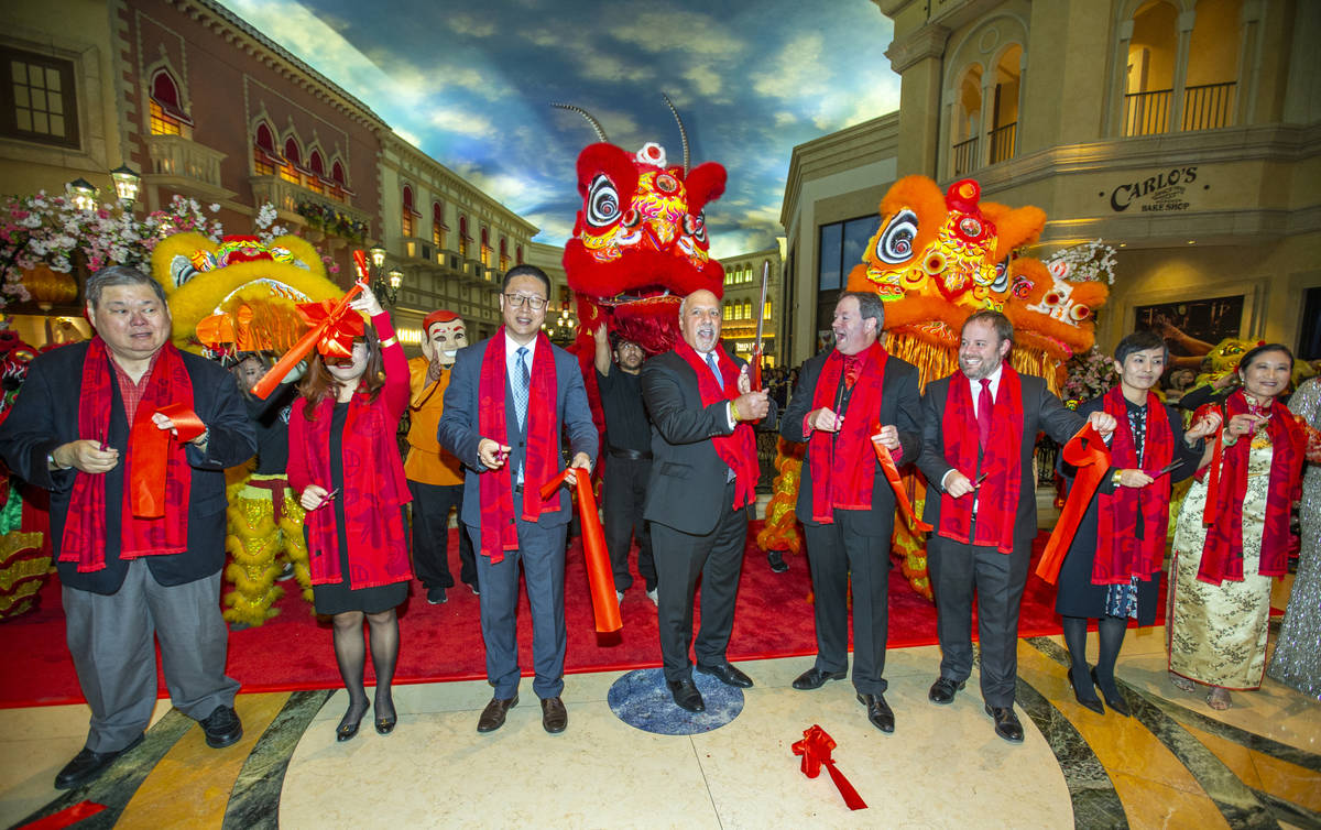 Dignitaries cut a ribbon to officially start the Grand Canal Shoppes' celebration of the Year o ...