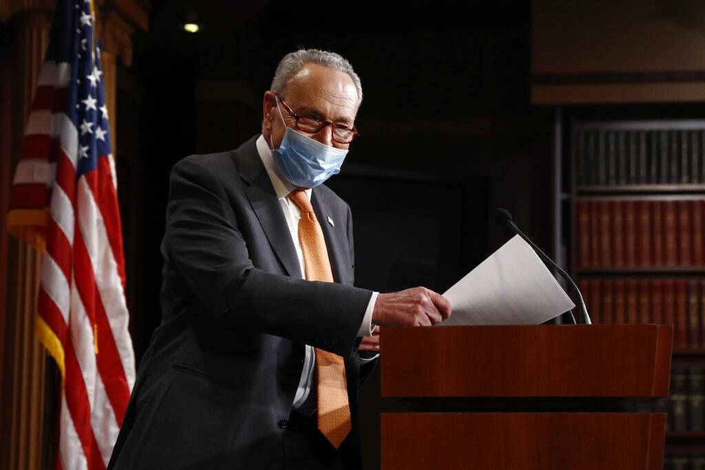 Senate Minority Leader Sen. Chuck Schumer of N.Y., center, arrives for a news conference on Cap ...