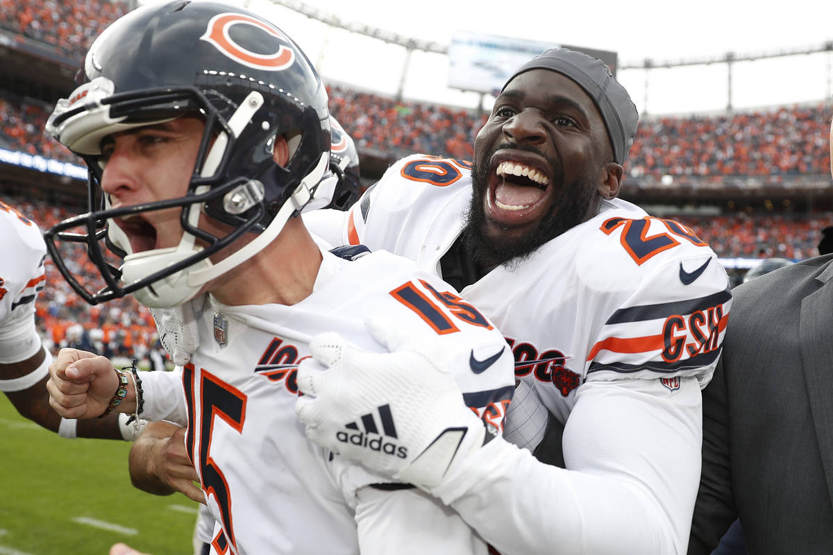 Chicago Bears kicker Eddy Pineiro, center, celebrates his game-winning field goal with free saf ...