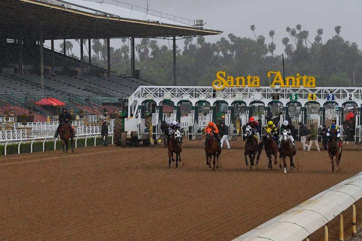 Horses run in the fourth race at Santa Anita Park in front of empty stands Saturday, March 14, ...