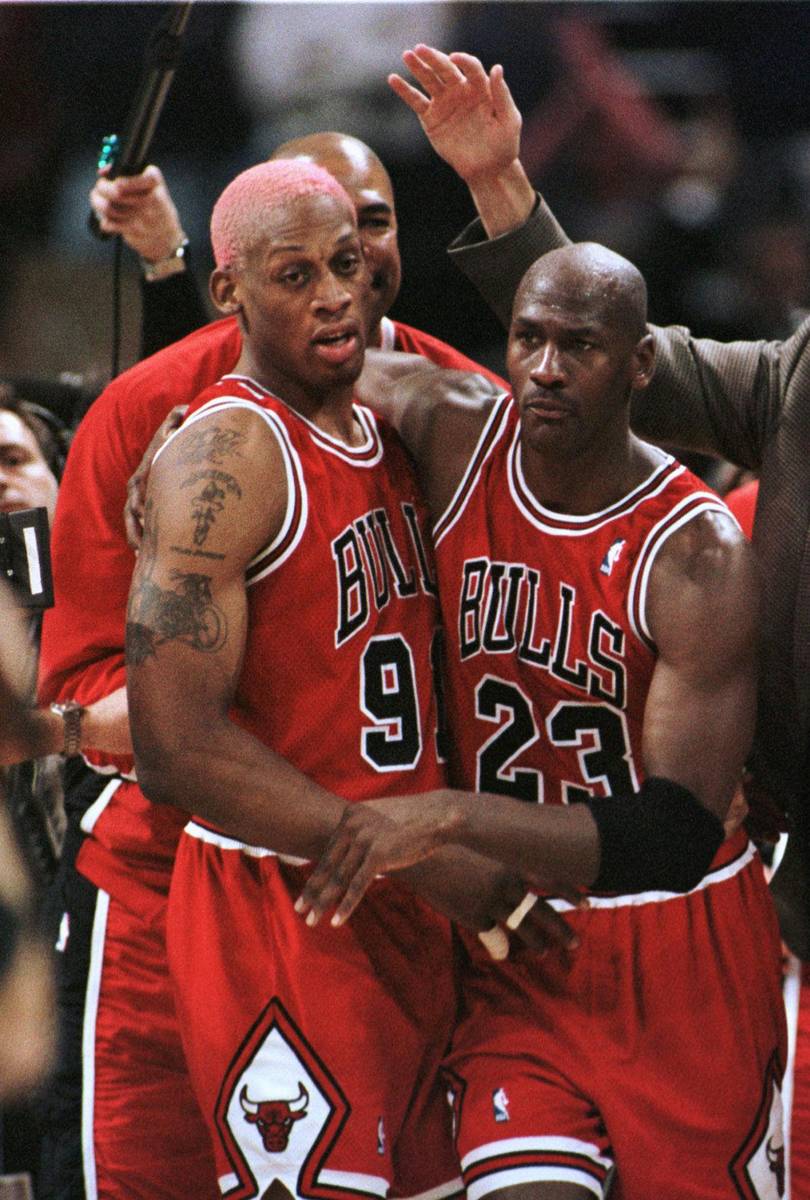 Chicago Bulls' Dennis Rodman, left, and Michael Jordan head off the court after beating the Mil ...