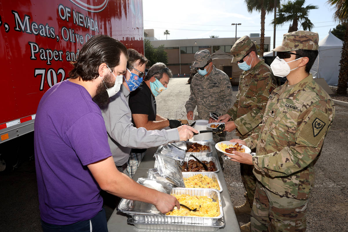 Nevada National Guard members who are helping with COVID-19 testing, including, from right, Spc ...