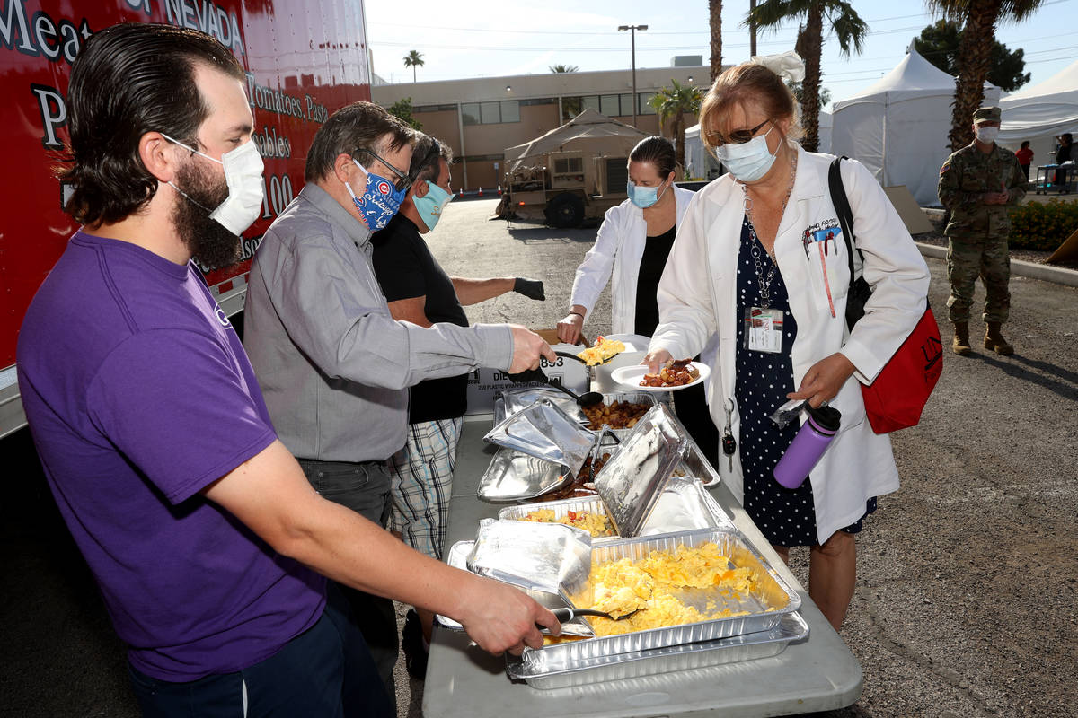 UNLV Medicine doctors Elissa Palmer, right, and Laura Shaw who are doing COVID-19 testing get b ...