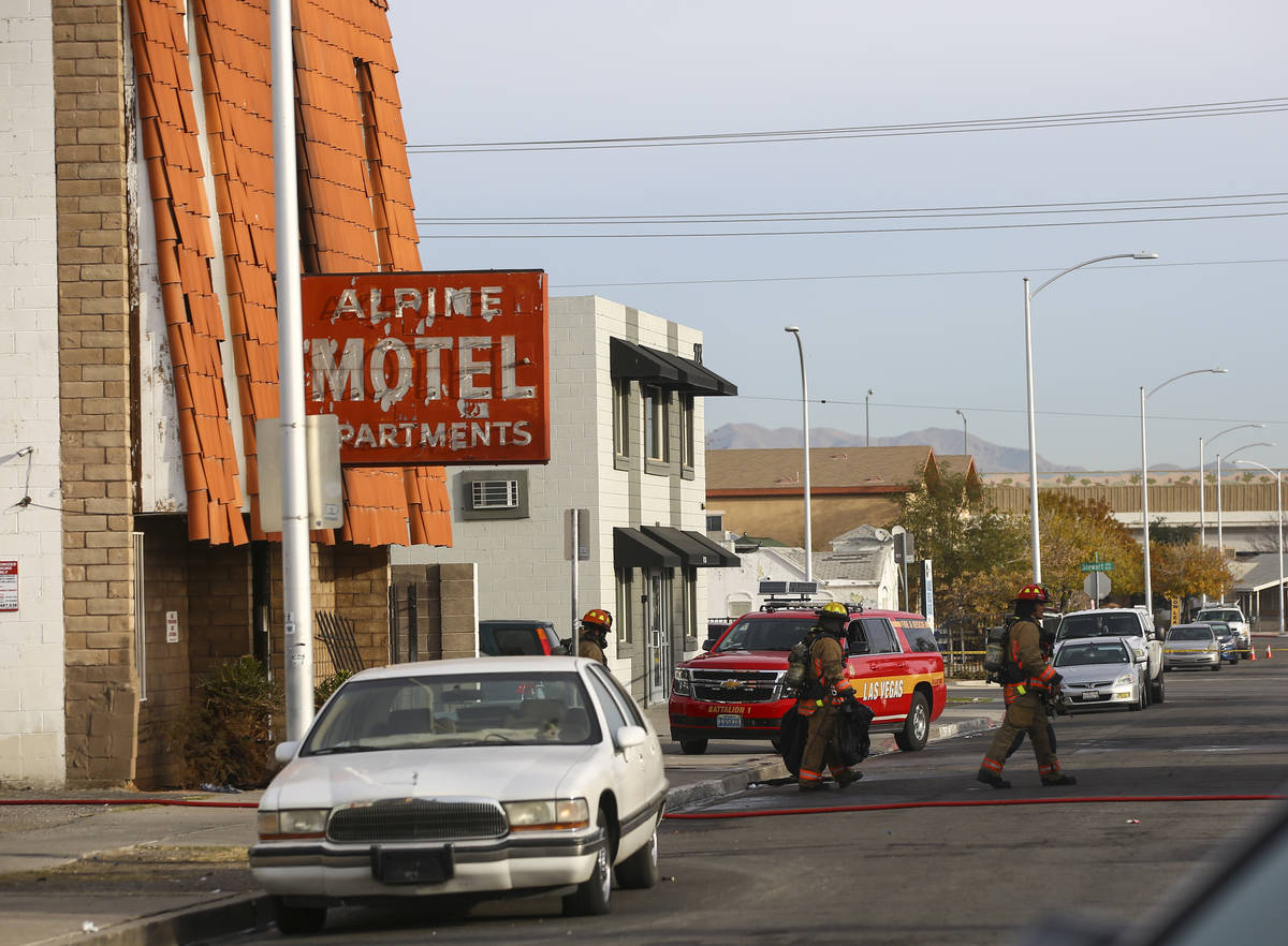 Las Vegas firefighters work the scene of a fire at a three-story apartment complex early Saturd ...