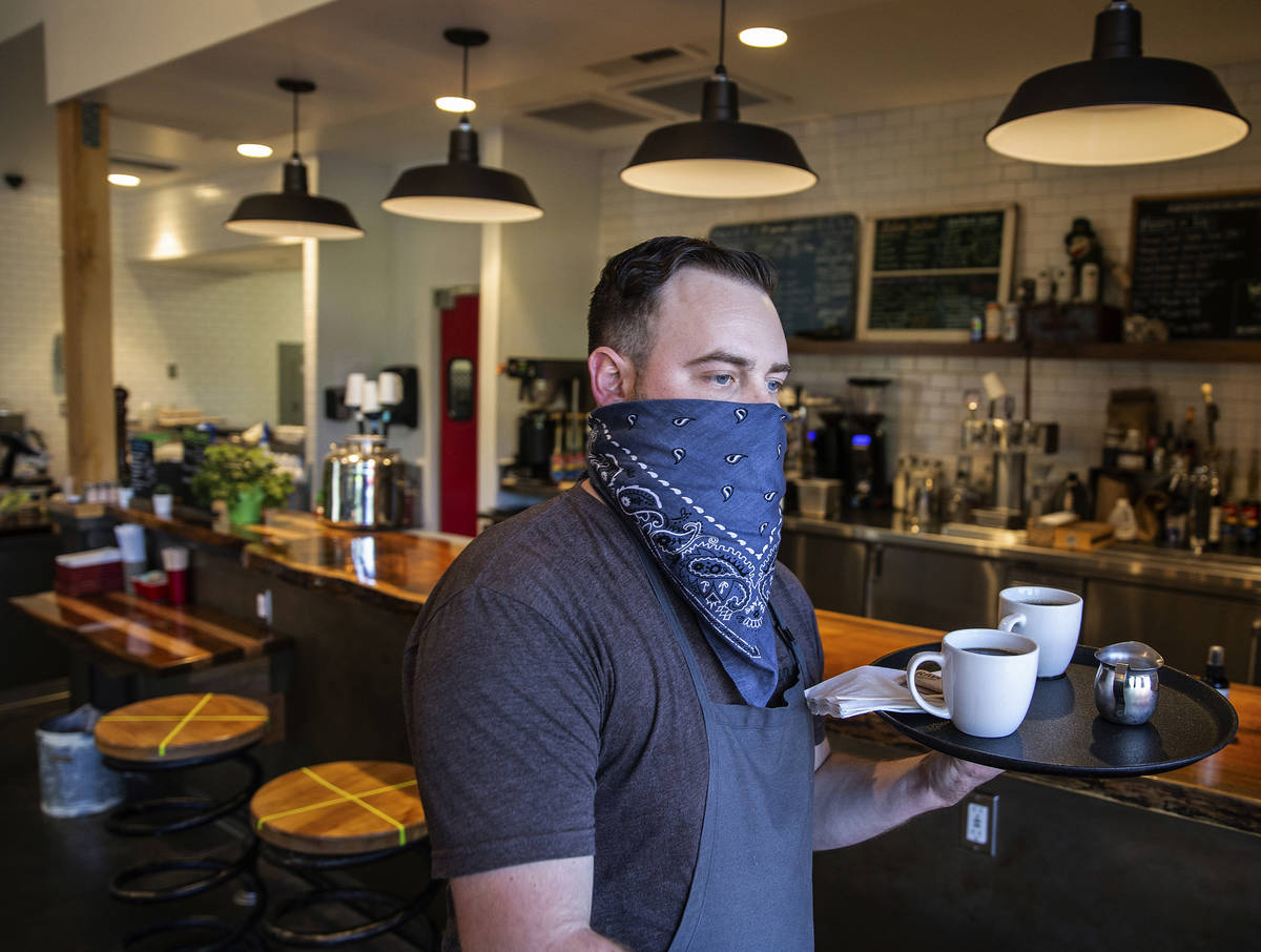 Jesse Reeder, a server at Cottonwood Station, brings coffee to diners on Wednesday, May 13, 202 ...