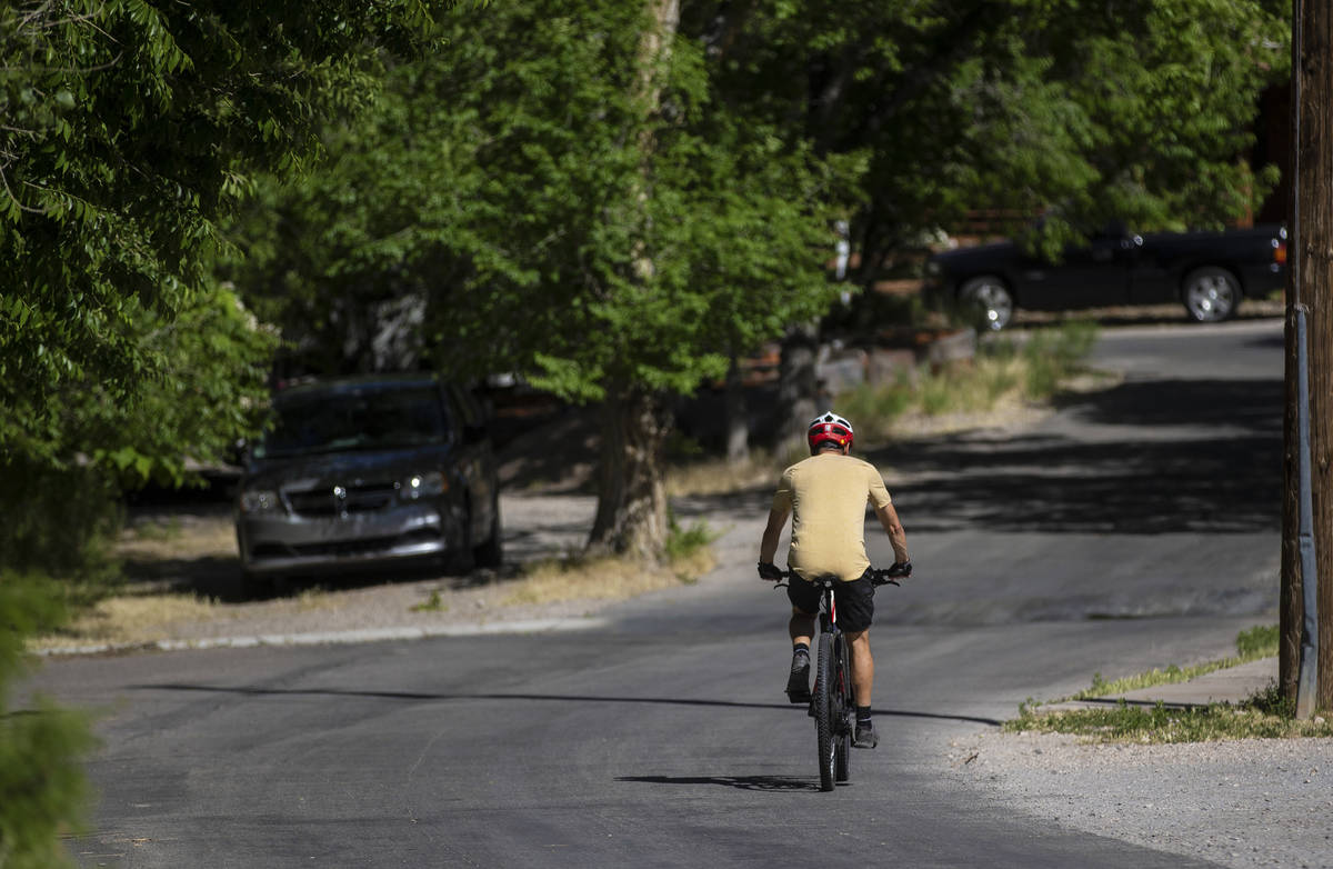 A cyclist bikes through downtown Blue Diamond in the late afternoon on Wednesday, May 13, 2020. ...