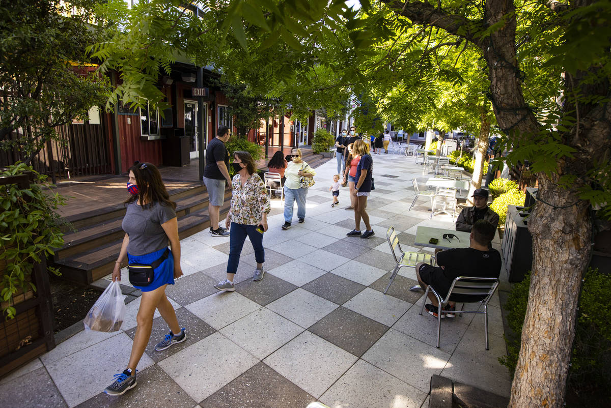 People walk around the Downtown Container Park on the first day of its reopening in downtown La ...