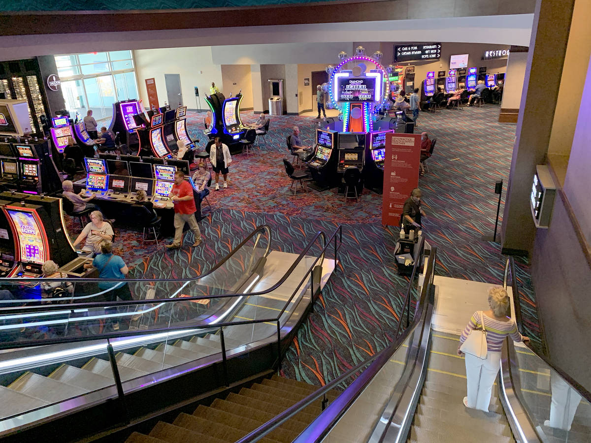 Individuals follow social distancing that is enforced during the reopening of Harrah's Ak-Chin ...