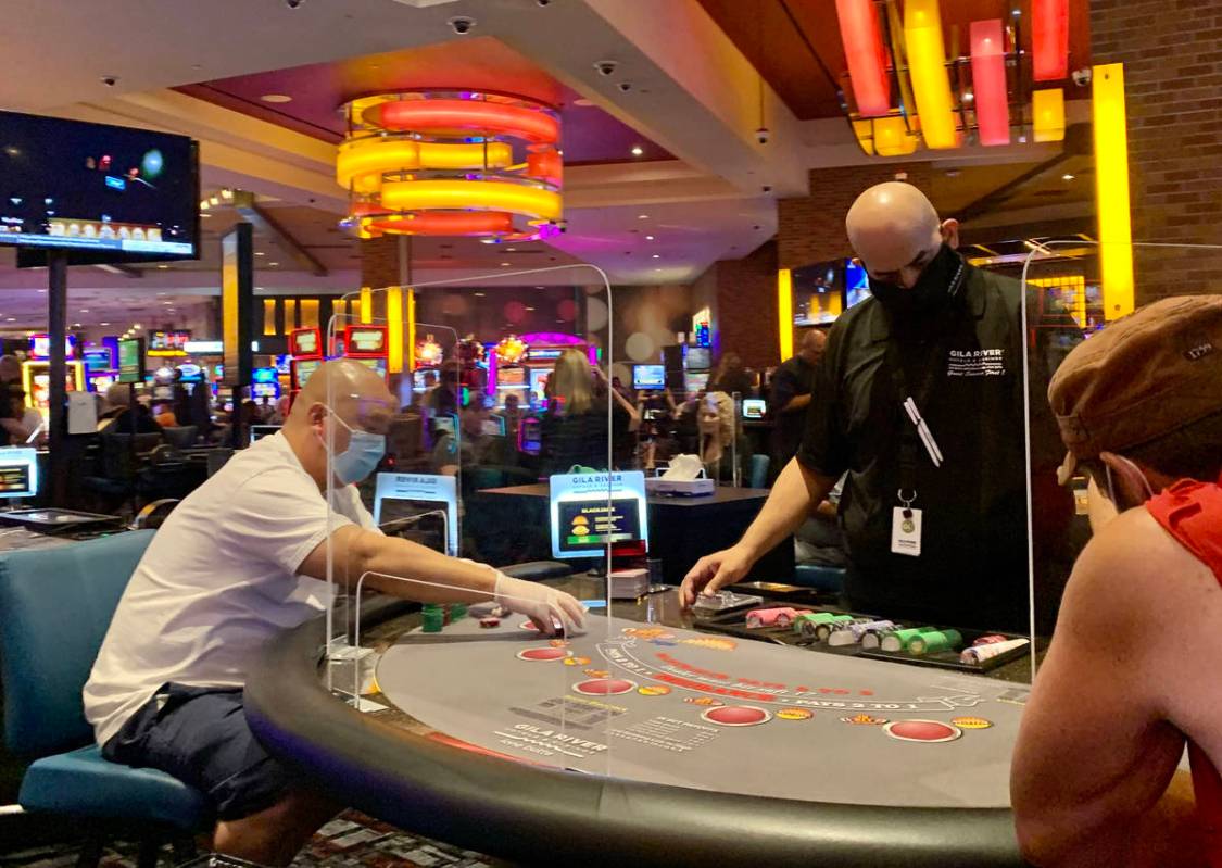 Individuals play table games at Gila River Casino's Lone Butte location on the packed reopening ...