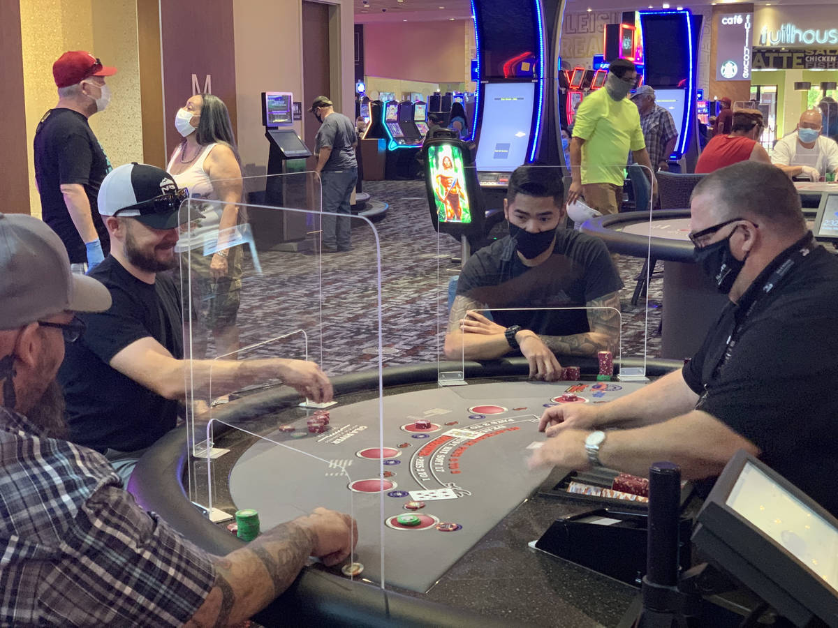 Individuals play table games at Gila River Casino's Lone Butte location on the packed reopening ...