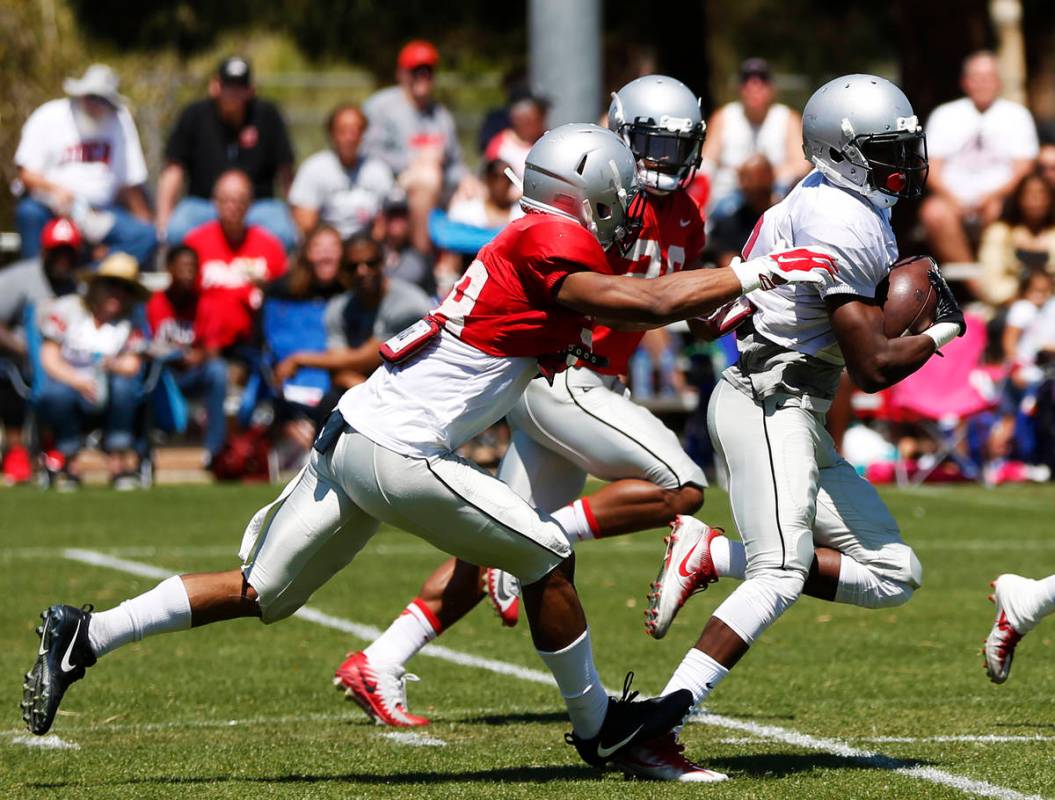 UNLV's wide receiver Mekhi Stevenson (2) runs the ball as defensive backs Ty'Jason Roberts (38) ...