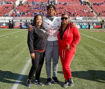 UNLV's Ty'Jason Roberts stands on the field with his aunt Kishawanda Bellos, left, and his moth ...