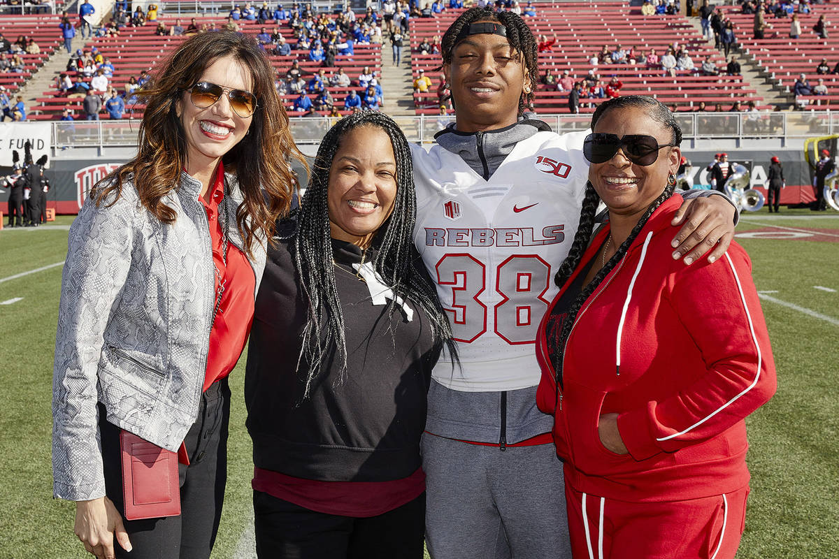 UNLV's Ty'Jason Roberts stands on the field with, from left, UNLV athletic director Desiree Ree ...