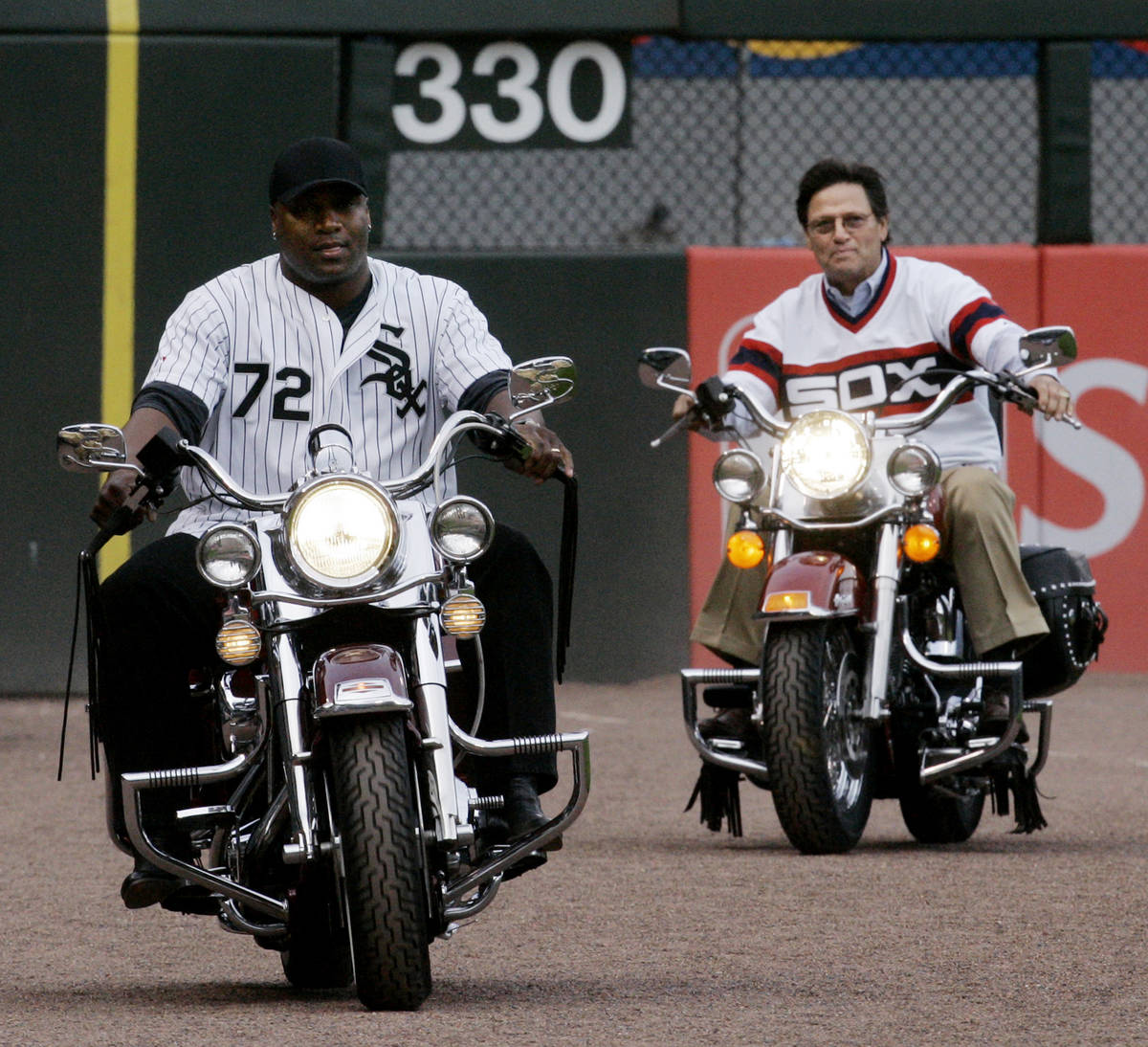 Bo Jackson, left, and Baseball Hall of Fame catcher Carlton Fisk ride into U.S. Cellular Field ...