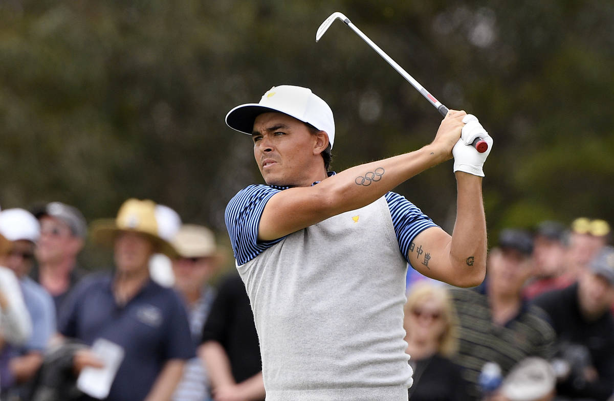 U.S. team player Rickie Fowler plays shot on the 16th hole in their foursomes match during the ...