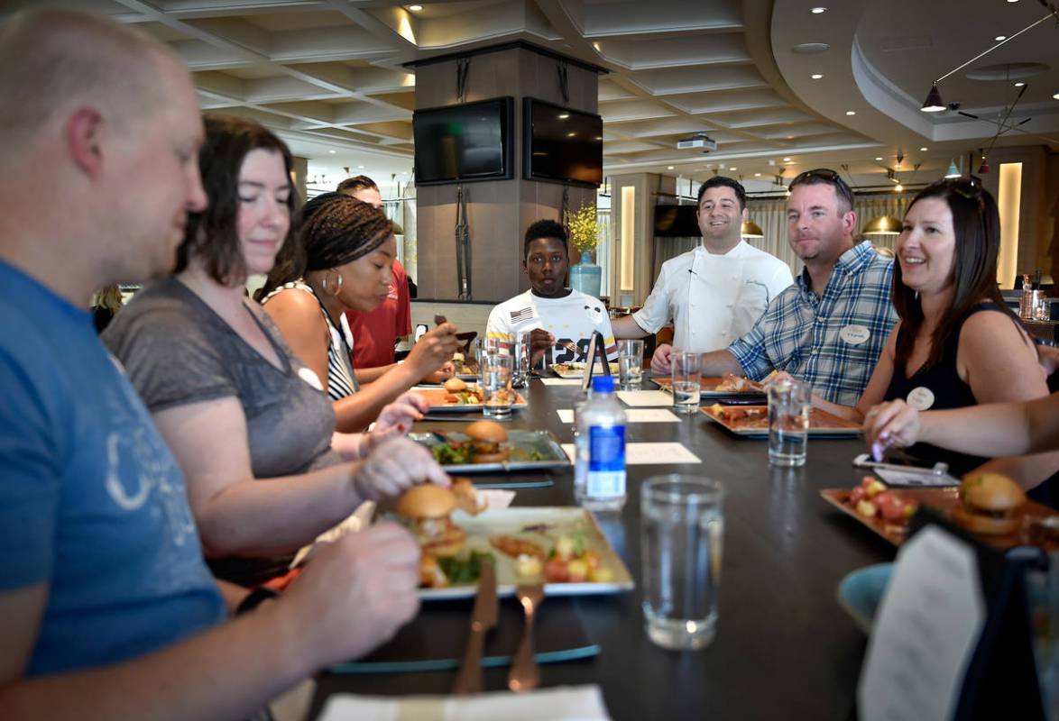 Herringbone restaurant chef Geno Bernardo, third from right, visits with customer during a Lip ...