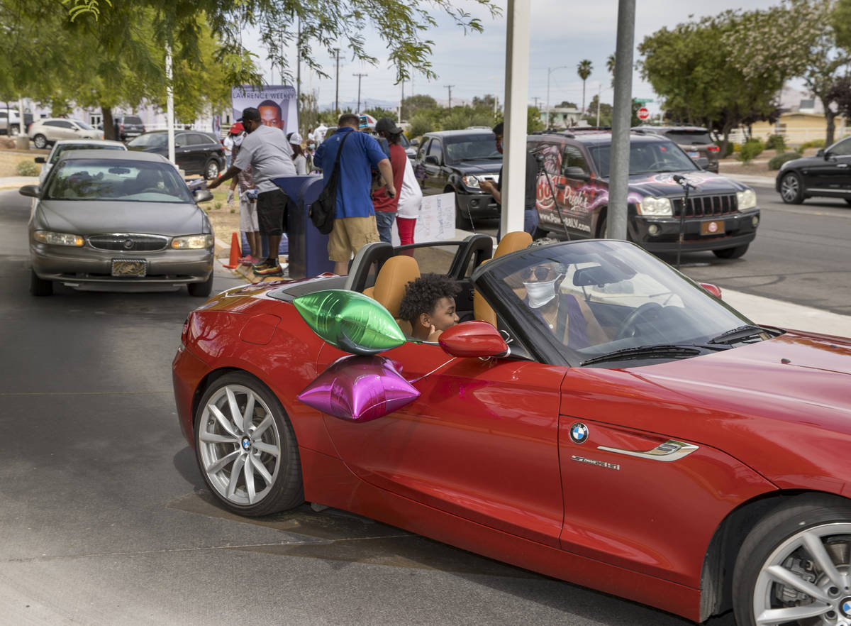 Drivers navigate past the reception area during a mail ballot drop-off parade at the at the U.S ...