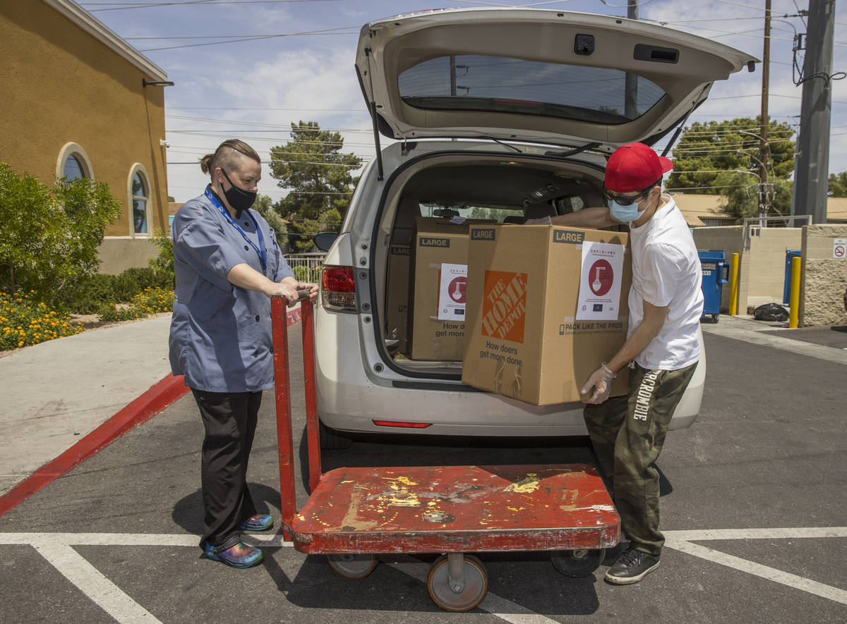Lindy Massey, left, with the Shannon West Homeless Youth Center holds a cart for China Mama Res ...