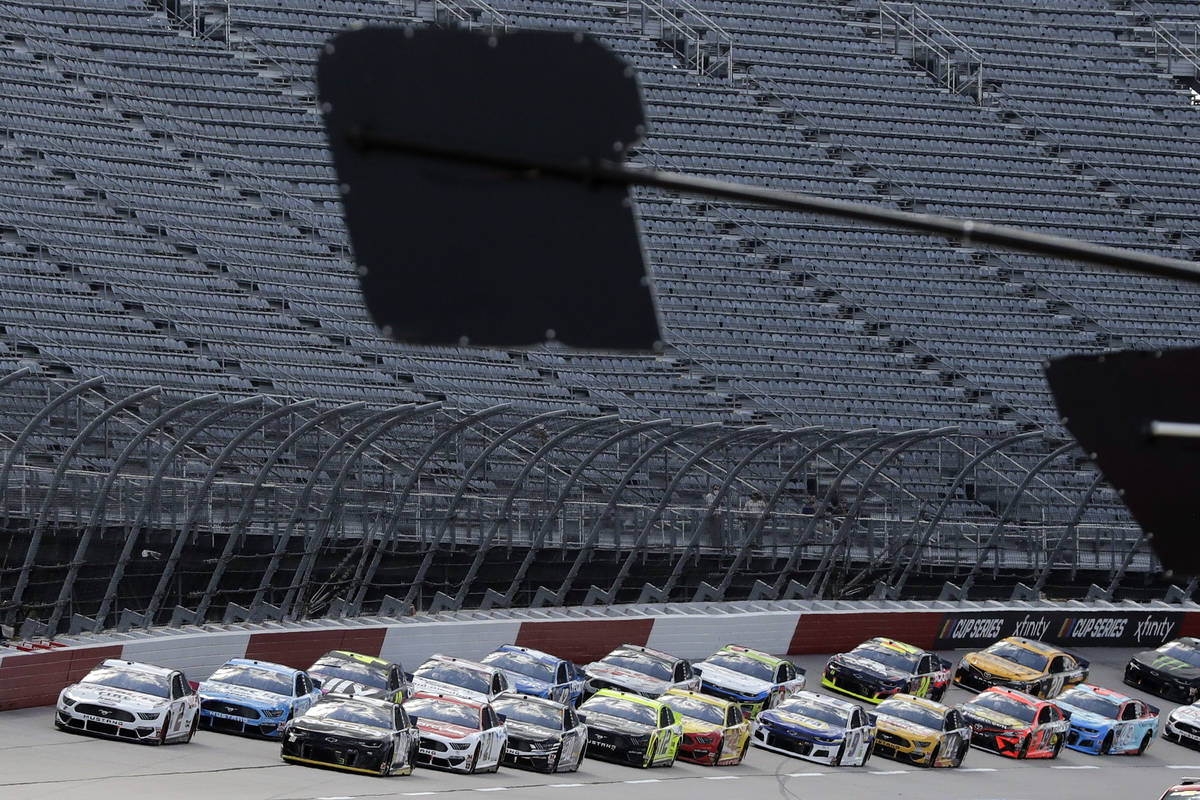 Cars approach the starting line in front of empty stands to start the NASCAR Cup Series auto ra ...
