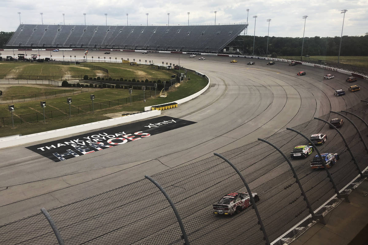 Cars go through a turn at Darlington Raceway during the NASCAR Cup Series auto race Sunday, May ...