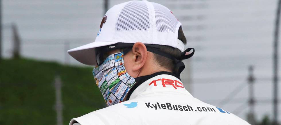 Kyle Busch wears a message to coronavirus pandemic responders on his back as he waits for the s ...