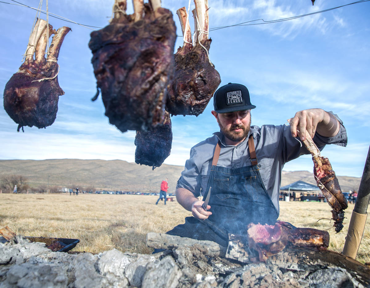 Chef Justin Kingsley Hall, with The Kitchen at Atomic, prepares cape grim tomahawk steaks durin ...