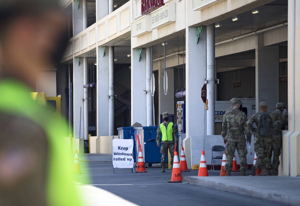 The Nevada National Guard waits for patients at the COVID-19 drive-through testing at the parki ...