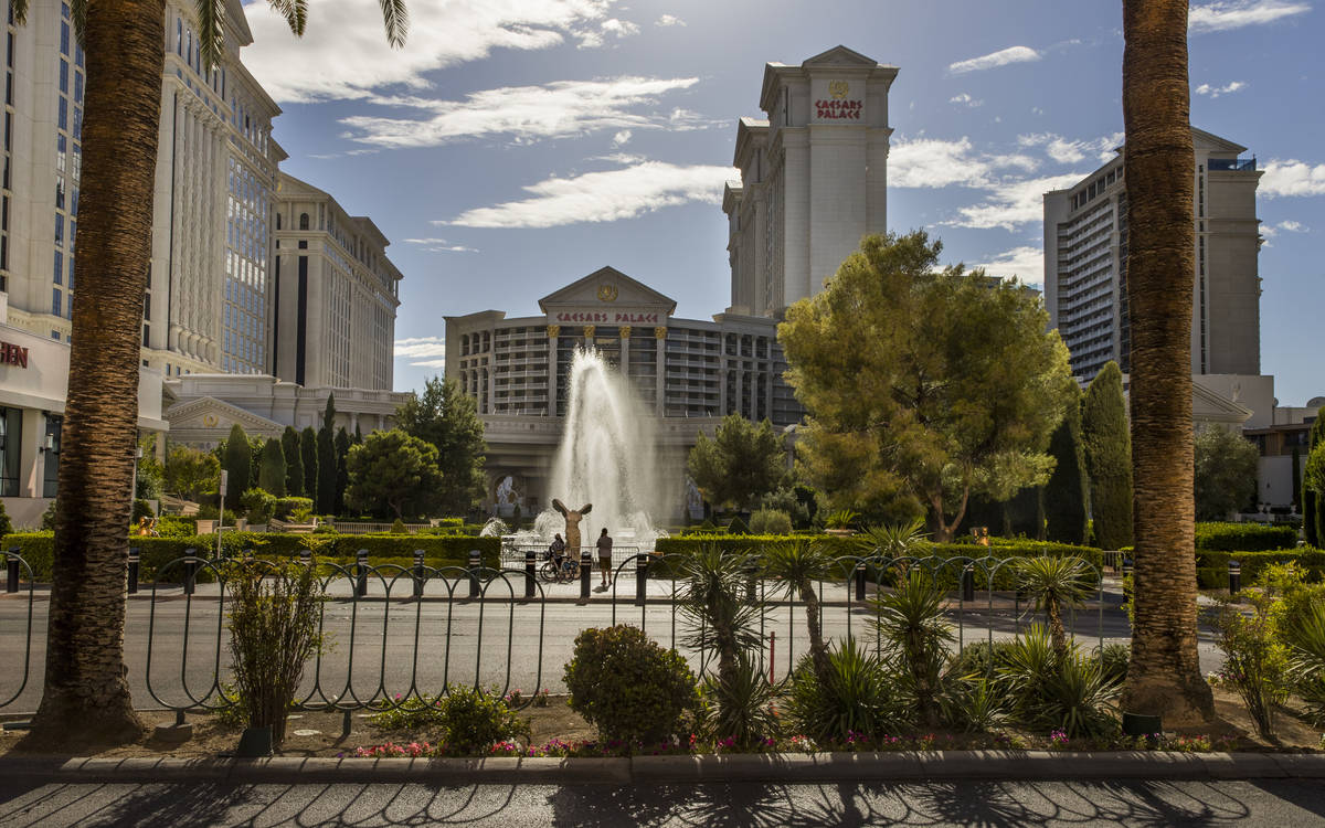 Cyclists pause to view the main Caesars Palace fountain area now back in operation on Monday, M ...