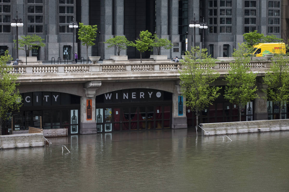 The Chicago River overflowed its banks and flooded the Riverwalk after overnight showers and th ...