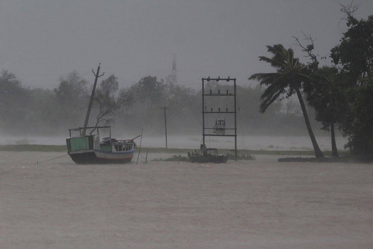 A boat stands anchored as it rains ahead of Cyclone Amphan landfall, at Bhadrak district, in th ...
