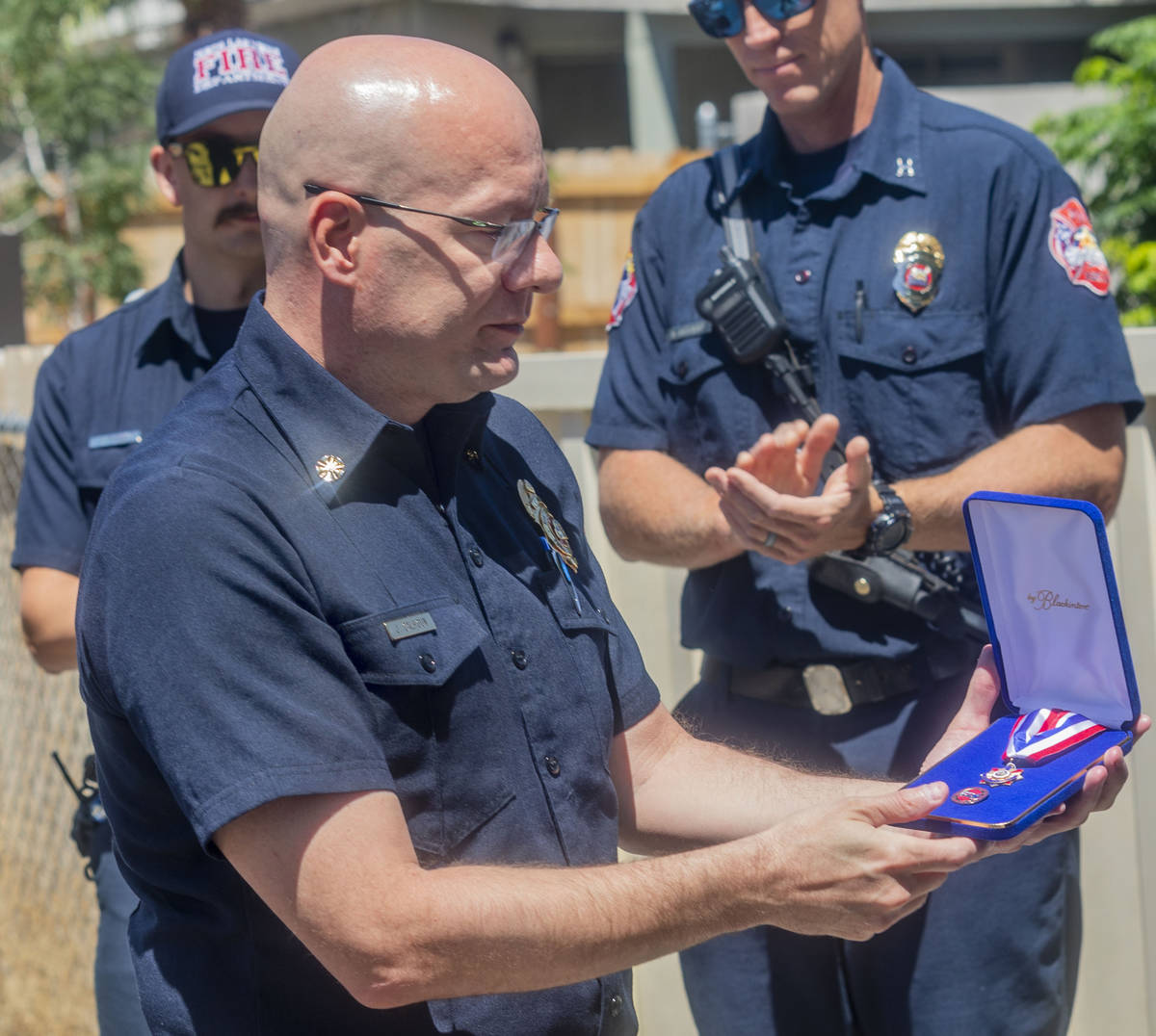 North Las Vegas Fire Chief Joseph Calhoun presents a medal of honor to civilian Jose Alvarado, ...