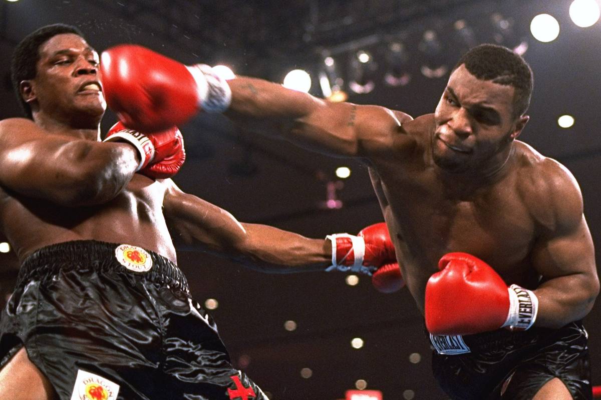 In this Nov. 22, 1986, file photo, Mike Tyson, right, delivers a blow to Trevor Berbick during ...